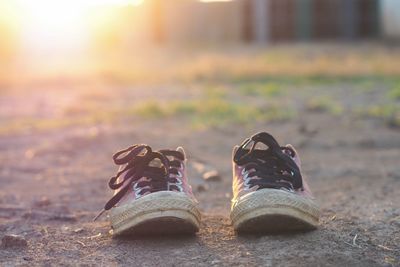 Close-up of shoes on ground during autumn