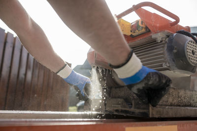 Close-up of man working in water