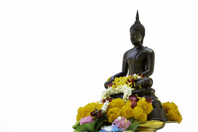 Statue of buddha against white background