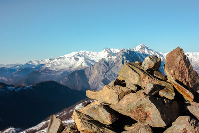 Scenic view of snowcapped mountains against clear blue sky