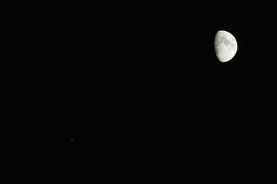 Low angle view of moon against clear sky at night