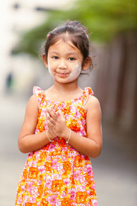 Portrait of cute girl standing outdoors