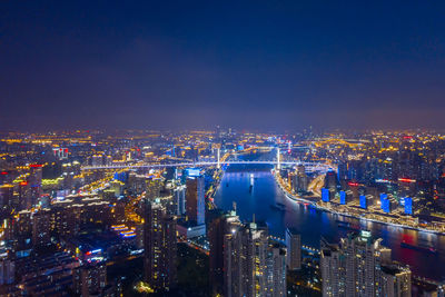 High angle view of city lit up at night