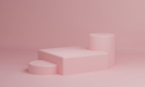 Close-up of pink candle over white background