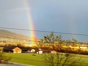 Scenic view of rainbow over landscape