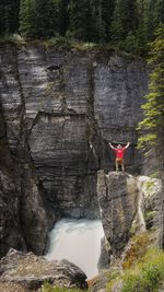 Rear view of man standing on cliff