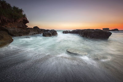 Scenic view of sea against clear sky during sunset