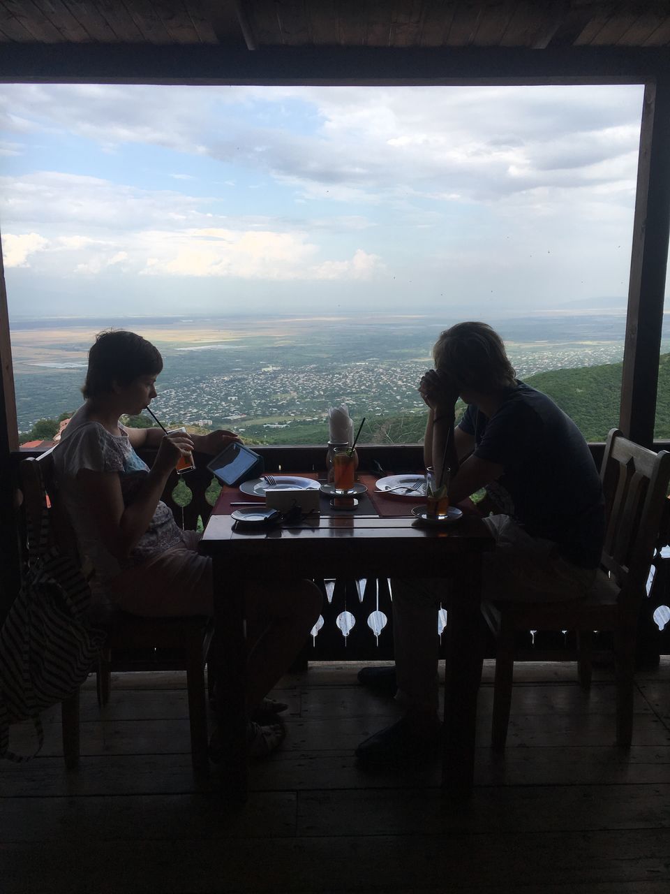 PEOPLE SITTING ON TABLE BY WINDOW