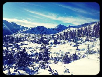 Scenic view of snow covered mountains against sky