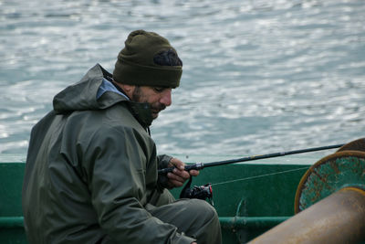 Side view of man working at harbor