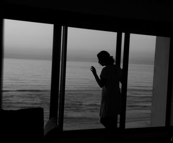 Silhouette of man standing on beach