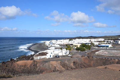 Scenic view of beach by sea against sky