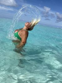 Side view of shirtless man in sea