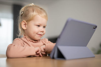 Portrait of cute boy using laptop at home