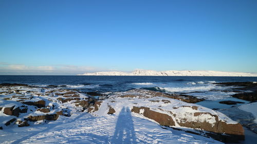 Scenic view of sea against clear blue sky