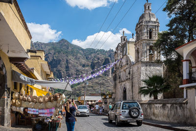 Rear view of woman photographing historic church at tepoztlan