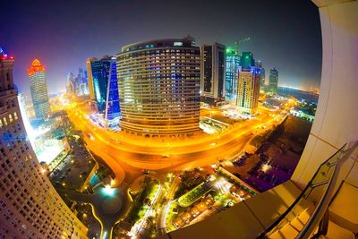 Illuminated cityscape against sky at night