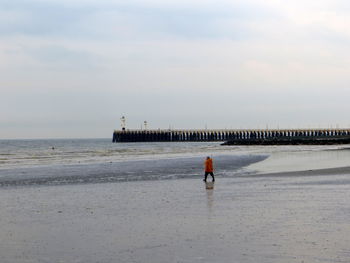 Man on beach against sky