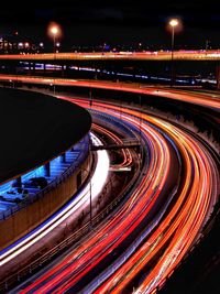 Light trails on road in city at night