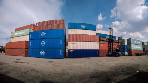 Stack of commercial dock by sea against sky