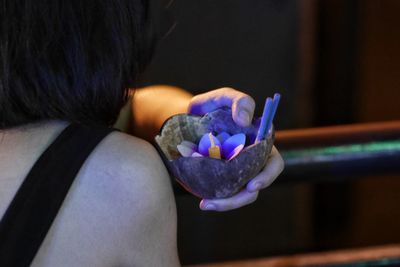 Rear view of woman holding multi colored flowers