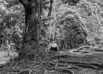 Full length of man on tree in forest