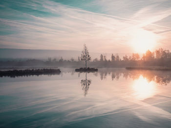 Scenic view of lake against sky during sunset