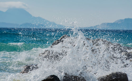 Waves at storm in mediterranean sea beating on breakwater on kos greece