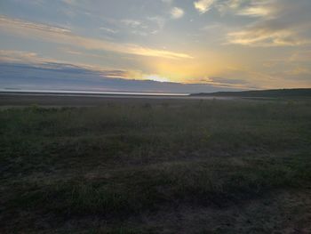 Scenic view of field against sky during sunset