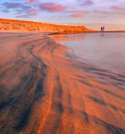 Scenic view of beach against sky during sunset