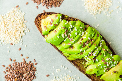 Healthy avocado toast on concrete background. wholegrain bread, sesame flax seeds. vegan keto diet