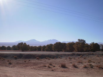 Scenic view of mountains against blue sky