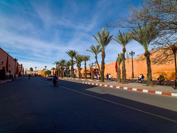 Cars on road against sky in city