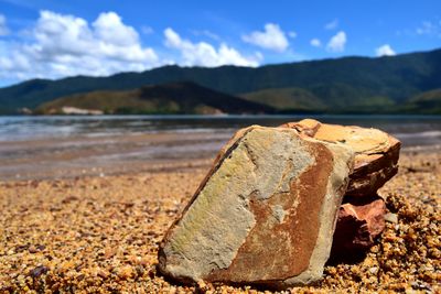 Close-up of rocks on beach against sky