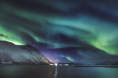 Scenic view of snowcapped mountains against sky at night