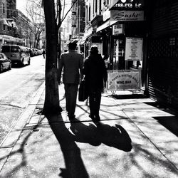 People walking on sidewalk in city