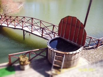 High angle view of metal railing by lake