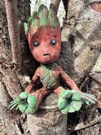 Close-up of toy on tree trunk