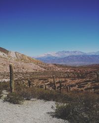 Scenic view of mountains against clear blue sky