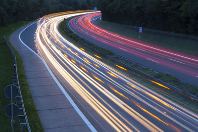 High angle view of light trails on road at night