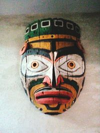 Close-up of multi colored face on wood