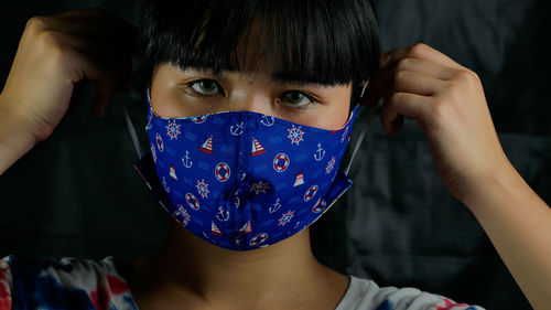 Close-up portrait of a girl covering face