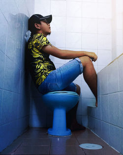 Side view of senior woman sitting in bathroom