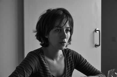 Portrait of young woman looking at home