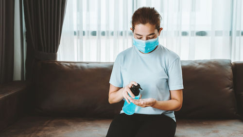 Young woman sitting at home