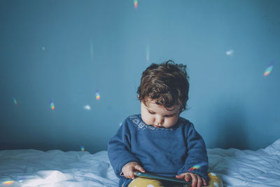 Cute baby girl on bed at home