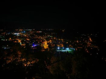 High angle view of illuminated buildings in city at night