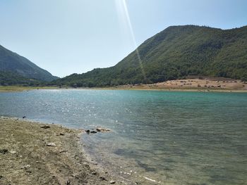 Scenic view of lake and mountains against sky