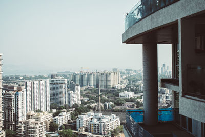 Buildings in city against clear sky