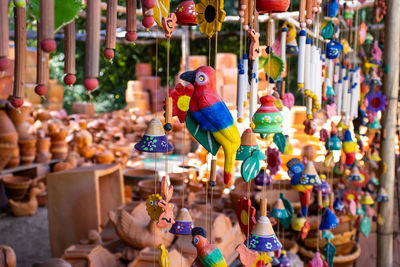 Close-up of multi colored decorations hanging for sale in market